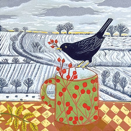 Lino print of a green jug with red berry pattern and a blackbird on the jug with red berries in tis mouth in front of snowy ploughed fields for art licensing